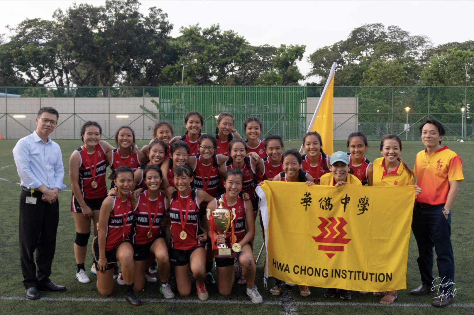 Touch Rugby team with Hwa Chong Institution banner